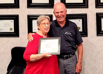 OPD5 Board member Dale Rust (right) is presented his NRECA Board Leadership Certificate by board chairwoman Judy Metz during an August board meeting. 
